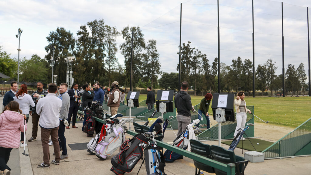 People at a Networking Event at Haggin Oaks's The Hang Out at the Driving Range. At the Hitting Bays
